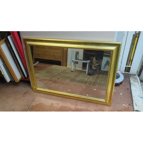 Rectangular wall mirror with a broad gilt-finish frame, coved moulding ...