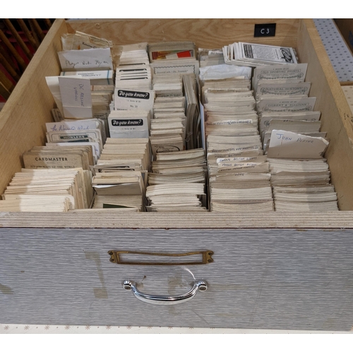 68 - Cigarette and Trade Cards; a large stock of mainly odd cards organised in seven drawers by company a... 