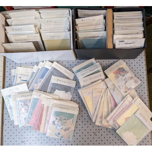 1005 - Mixed Lots; two small boxes with many hundreds of world stamps sorted into packets.