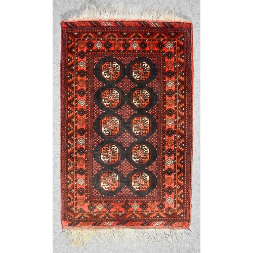 149 - A 20th Century Turkman Prayer Rug woven in colours of ivory, navy blue, wine and fawn, the field fil... 