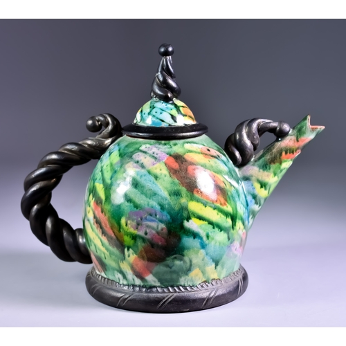 174 - David Constantine White (1948-2011) - A slip decorated earthenware teapot and cover on a plinth base... 