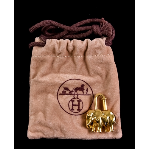 181 - A Hermes Gilt Metal Cadena Elephant Padlock Charm and Hermes pouch