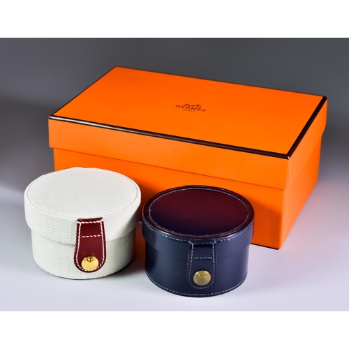 184 - Two Hermes Circular Watch Boxes one in natural herringbone canvas 2.5ins high, the other in navy lea... 