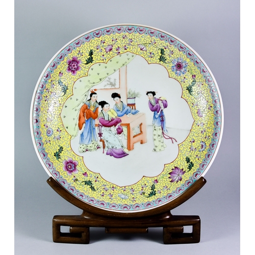 21 - A Chinese Porcelain Circular Charger, 20th Century, enamelled with four women in an interior around ... 