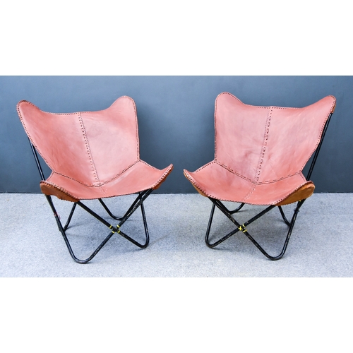 247 - A Pair of Mid-Century Sri Lankan Lounge Chairs, each with tanned leather covers, on black metal X-pa... 