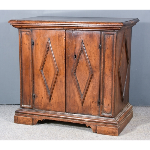 254 - A 17th Century Italian Walnut Cabinet, with moulded edge to top, fitted one shelf enclosed by a pair... 