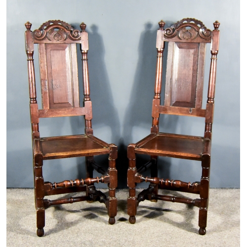 262 - A Pair of 17th Century Oak High Back Dining Chairs, each with scroll and floral carved cresting, fie... 