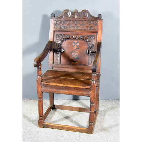 266 - A 17th Century Oak Arm Chair of 'Wainscot' Design, with leaf and scroll carved crest rail, wide frie... 