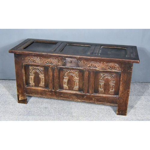 269 - A 17th Century Panelled Oak Coffer, with three panels to top, the frieze carved with lunettes and th... 