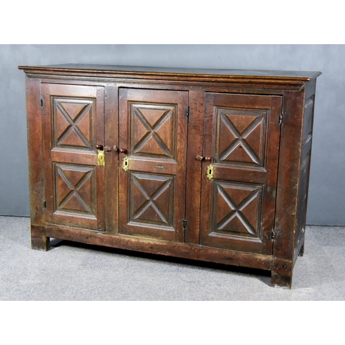 276 - An Old Continental Panelled Oak Dwarf Cupboard, with moulded edge to top, enclosed by three twin pan... 