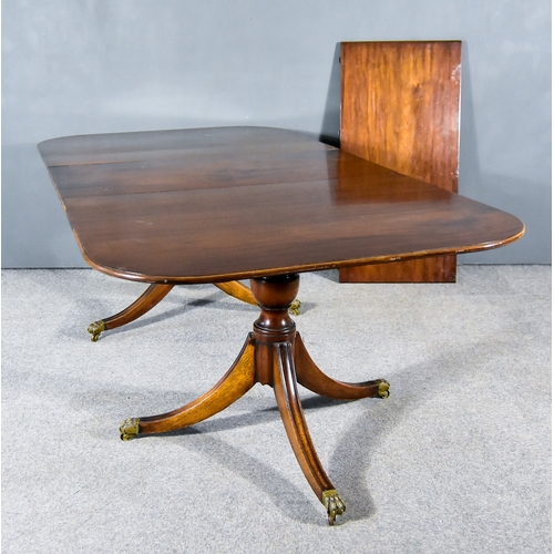 283 - A George III Figured Mahogany Twin Pedestal Extending Dining Table, with moulded edge to top, on twi... 