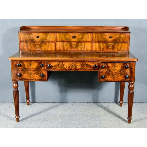 306 - An Early Victorian Mahogany Kneehole Writing Table, with tray top superstructure fitted six drawers,... 