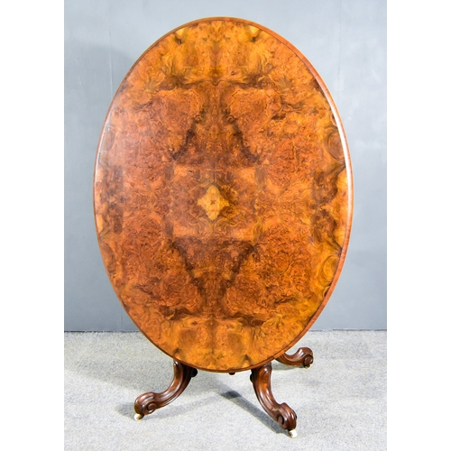 309 - A Victorian Figured Walnut Oval Breakfast Table, with quarter veneered panels and moulded edge to to... 