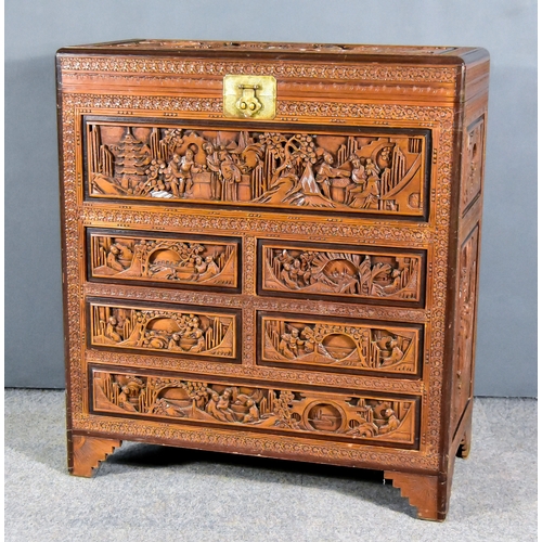 31 - A Carved Camphor Wood Chest, Late 19th/Early 20th Century, the whole carved with stylised floral dec... 