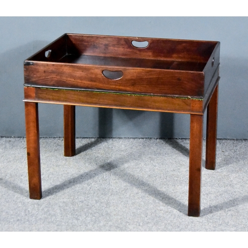 320 - A 19th Century Figured Mahogany Rectangular Butler's Tray on Stand, the tray top with four handle cu... 