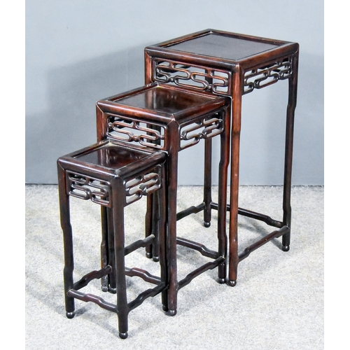 845 - A Nest of Three Chinese Rosewood Occasional Tables,Â with panelled tops, the aprons with fretted scr... 