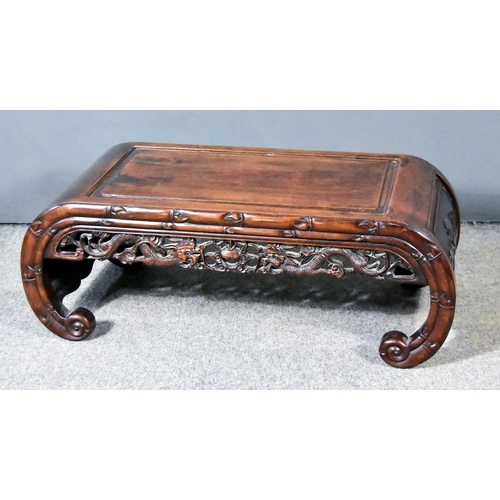 855 - A Chinese Hardwood Opium Table,Â the curved and panelled ends carved with bats, the aprons fretted a... 