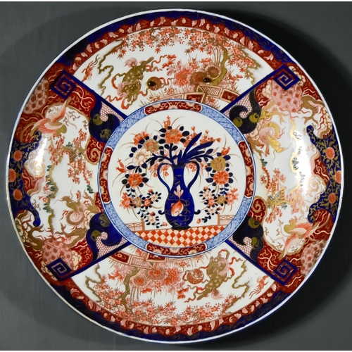 869 - A Japanese Porcelain Imari Charger, enamelled in blue, orange, green and gilt with a central reserve... 