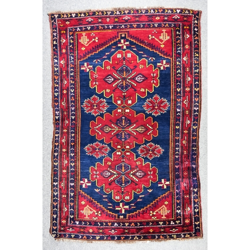 908 - A 20th Century Hamadan Rug woven in colours of ivory, navy blue and wine, with three central shaped ... 