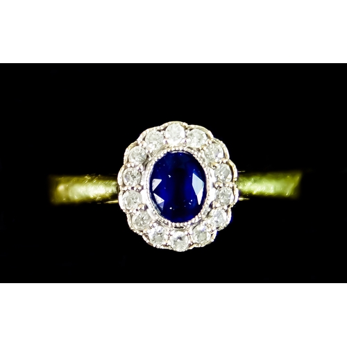 595 - An 18ct Gold Sapphire and Diamond Ring, set with a centre faceted sapphire stone of approximately .5... 