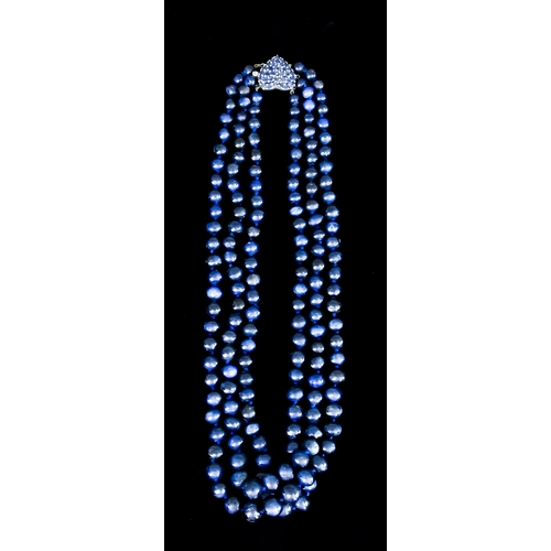 596 - A Triple String of Sapphire Beads, with 14ct white gold heart-shaped clasp set with faceted sapphire... 