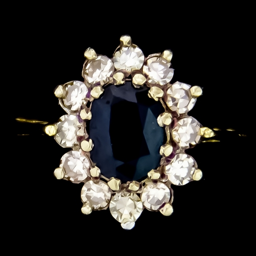 598 - An 18ct Gold Sapphire and Diamond Ring, set with a centre sapphire stone of approximately .50ct surr... 