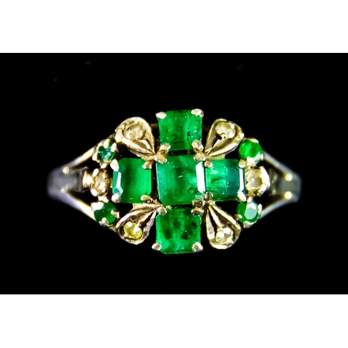599 - A White Metal Emerald and Diamond Ring, set with five faceted emerald stones in the form of a centra... 