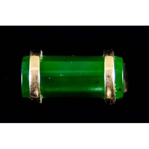 601 - An 18ct Gold Jade Set Ring, set with a tubular jade or jadite stone to the top, size N, total gross ... 
