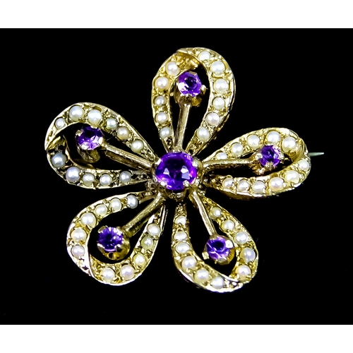 612 - A 9ct Gold Amethyst and Seed Pearl Brooch, of floral design set with five faceted amethyst stones su... 