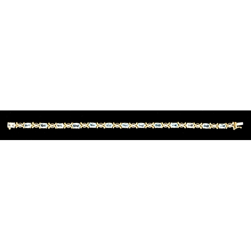 618 - A 9ct Gold Blue Topaz and Diamond Bracelet, set with fourteen faceted blue topaz stones interspaced ... 
