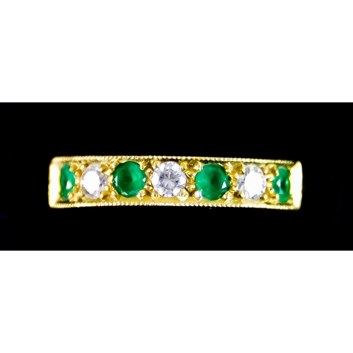 621 - An 18ct Gold Seven Stone Diamond and Emerald Ring, set with four small faceted emerald stones and th... 