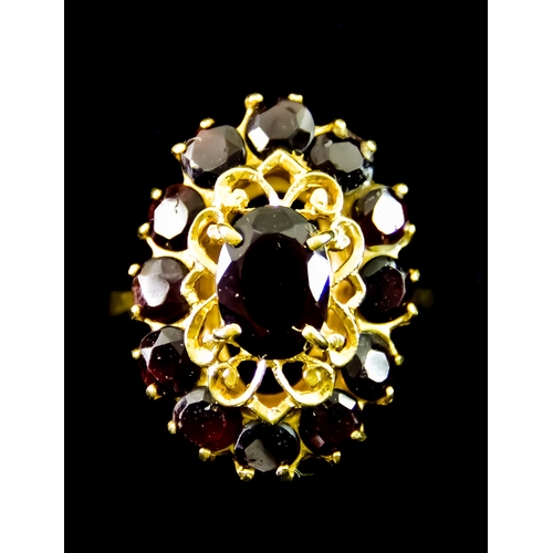 625 - A Yellow Metal Garnet Dress Ring, set with faceted garnet stones in the form of a dress ring, size P... 