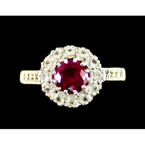 631 - A 9ct Gold Faceted Red and White Stone Ring, set with a centre red faceted gem stone, surrounded by ... 