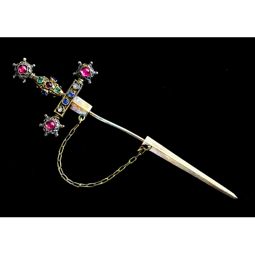 633 - A Yellow Metal Lapel Pin, in the form of a sword, set with faceted and cabochon blue, white, red and... 