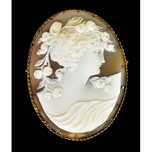 651 - A Yellow Metal Carved Cameo Brooch, framing a carved shell cameo bust of a young lady with floral ar... 
