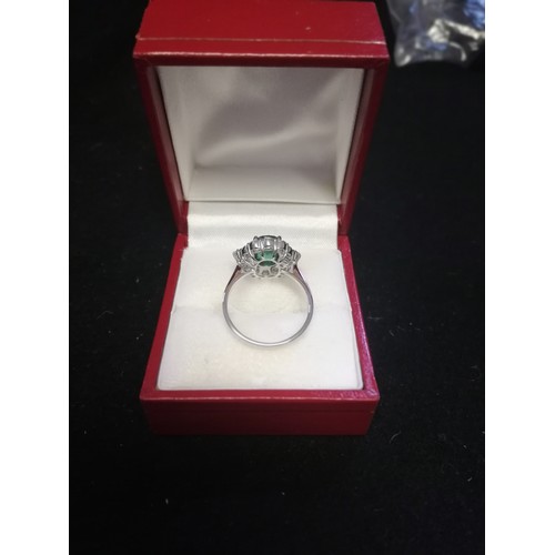 19 - 18ct white gold emerald & diamond ring set with central oval shaped emerald (1.79ct) & a total diamo... 