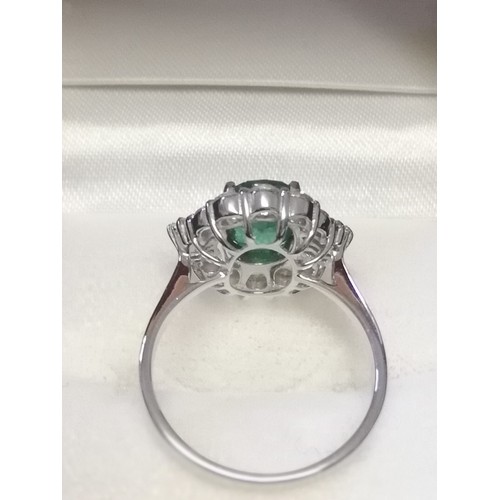 19 - 18ct white gold emerald & diamond ring set with central oval shaped emerald (1.79ct) & a total diamo... 