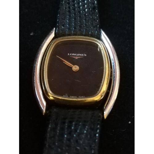65 - Longines ladies bi-metal wristwatch on leather strap
-manual wind & in running order