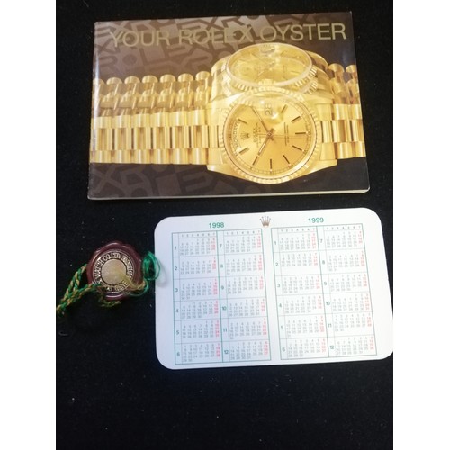 80 - Rolex oyster booklet t/w calendar card & swing tag dated 1998