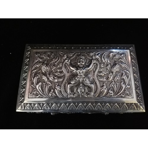90 - Asian silver embossed cigarette box with wood interior
-8¼