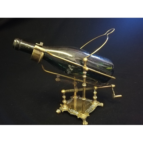 24 - Antique brass mechanical wine bottle pourer with pad feet (bottle not included) - height 14½