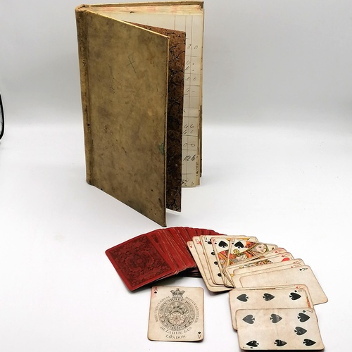 105 - Vellum covered accounts book t/w antique part set of playing cards