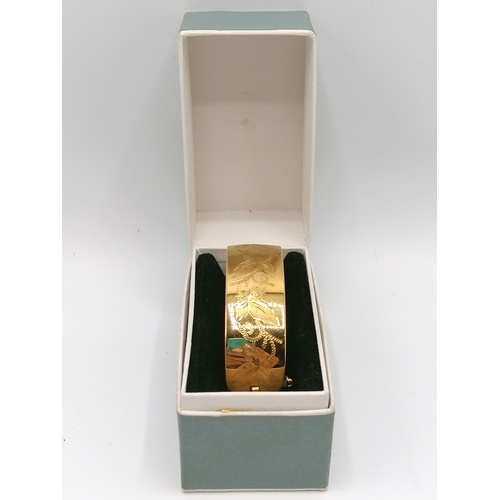 279 - Rolled gold bangle, boxed. weight 52g.