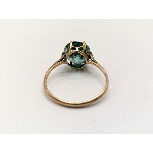 290 - Unmarked gold ring set with blue stone solitaire