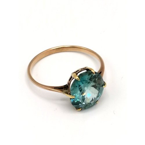 290 - Unmarked gold ring set with blue stone solitaire