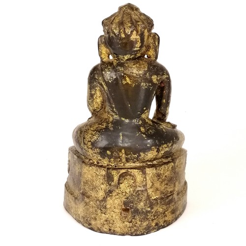 23 - Black lacquered wooden carved effigy of Buddha with gold sponged decoration - height 8