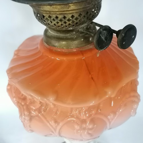 521 - 2 antique oil lamps the orange one has a crack to the reservoir otherwise in good condition