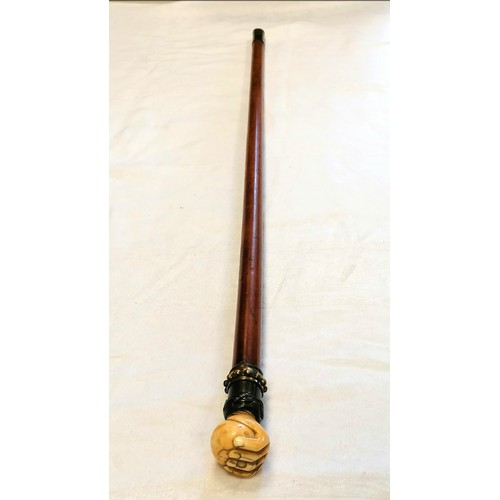 627 - Malacca walking cane with an antique ivory hand holding a ball with a metal mount