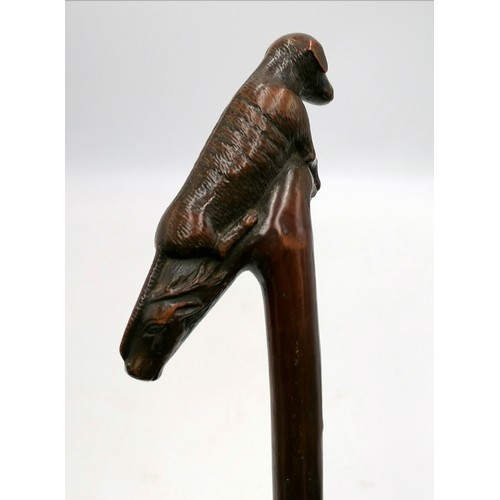 628 - Antique 1 piece carved wood walking stick with a handle depicting a hound & a stags head