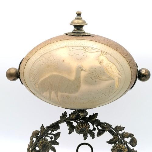 7 - Novelty emu egg mounted on a decorative nickel plated & wooden base stand sporting a clock to the ce... 